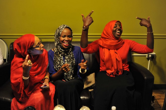 Somali women listen to an open mic night at Café Royale, a newly opened Somali-owned café on Lake Street.