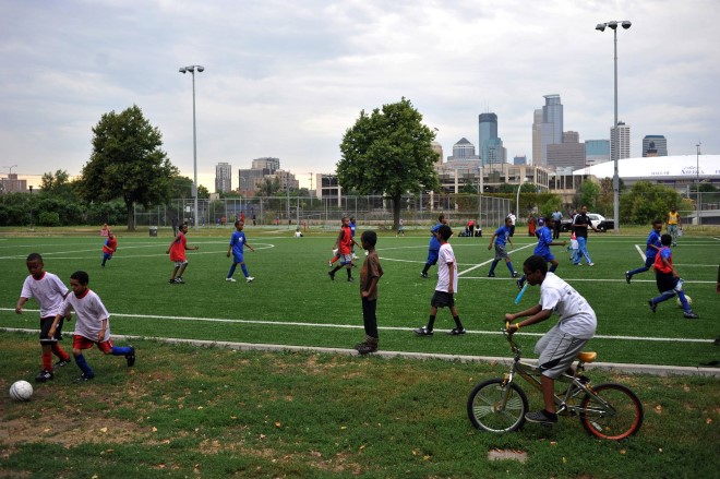 Somali youth play football in the Cedar Riverside neighborhood overlooking downtown Minneapolis.