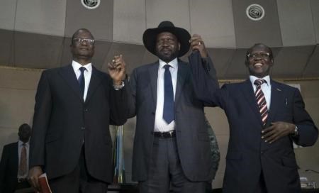 South Sudan"s President Salva Kiir (C) holds hands with First Vice President Taban Deng Gai (L) and Second Vice President James Wani Igga (R) inside the Presidential Palace in the capital of Juba, South Sudan, July 26, 2016.
