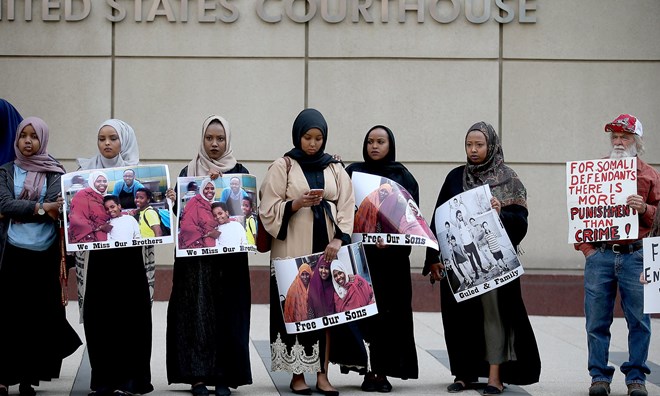 Supporters and family members of the Somali- American men accused of trying to join Isis protest outside the federal courthouse in Minneapolis.
Photograph: Elizabeth Flores/AP